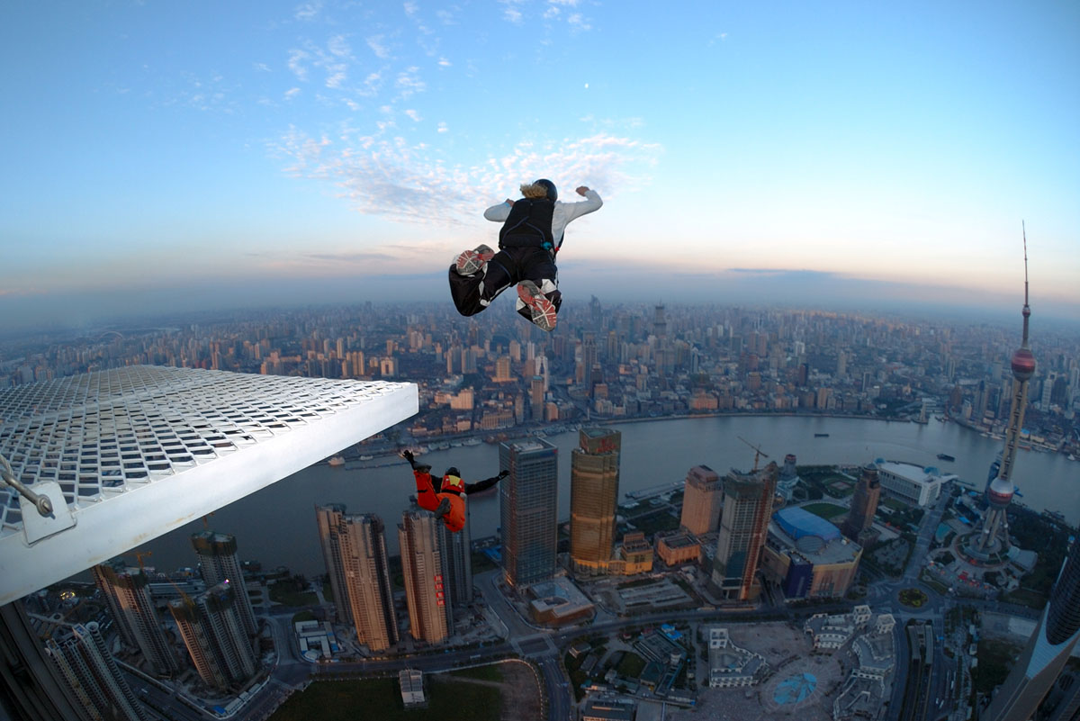 A base jumper jumping from a very high tower.