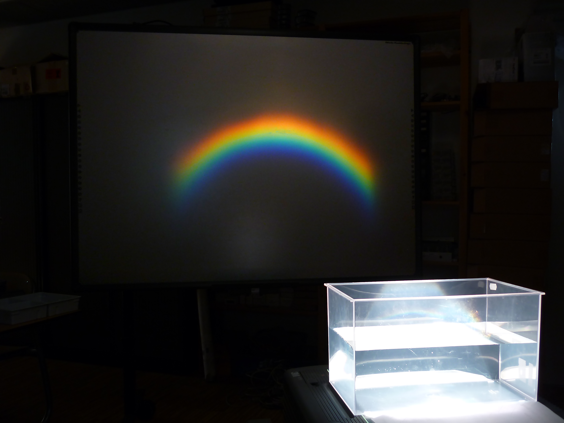 illuminated aquarium and a rainbow at the wall