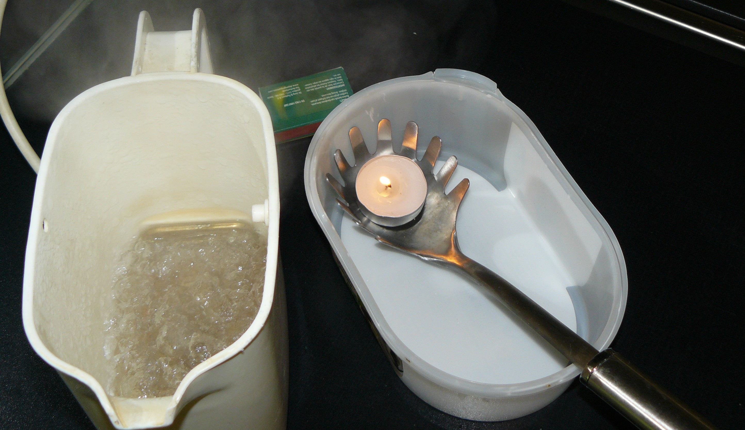 boiling water and a small tealight which is lit
