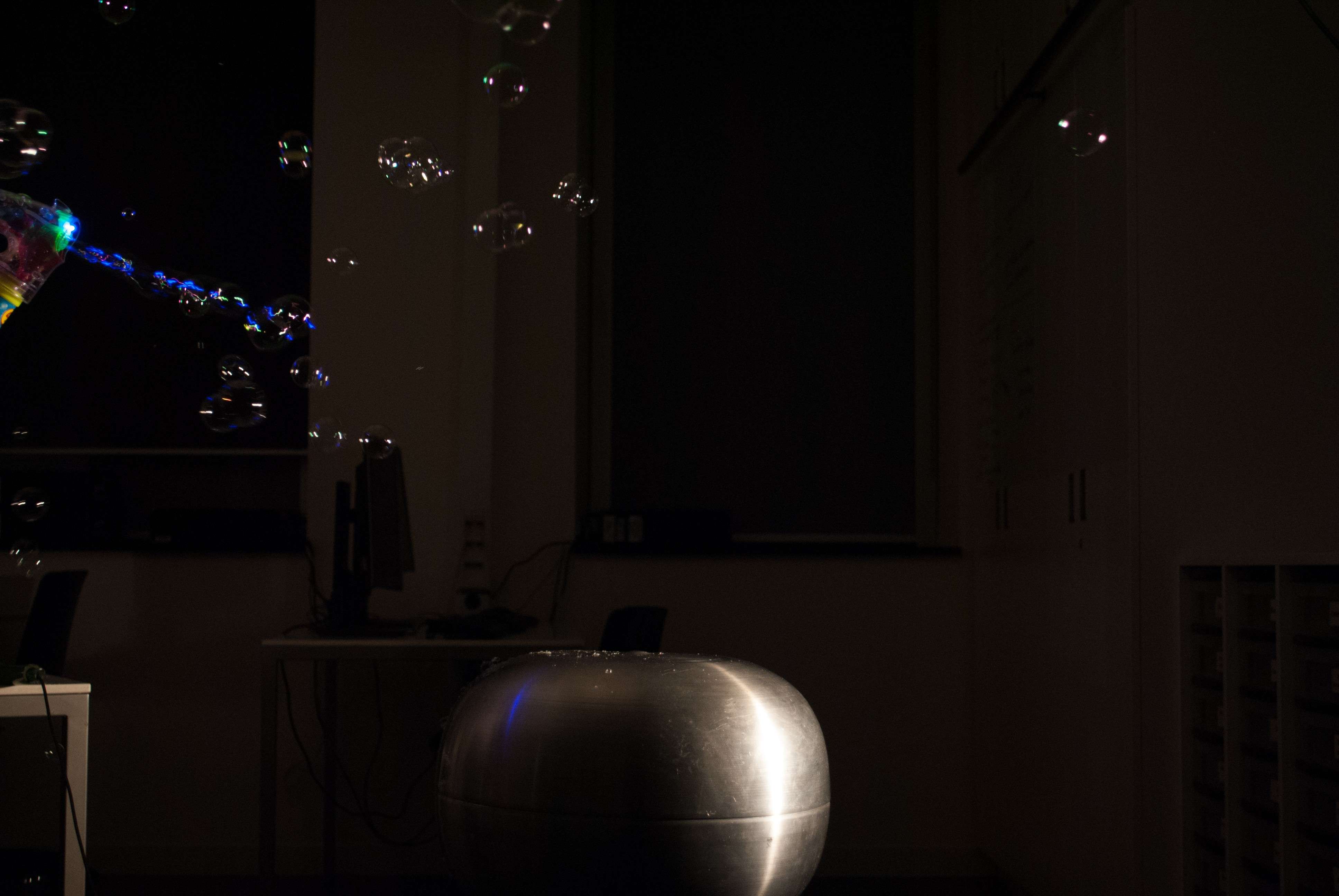 soap bubbles above a Van de Graaff generator