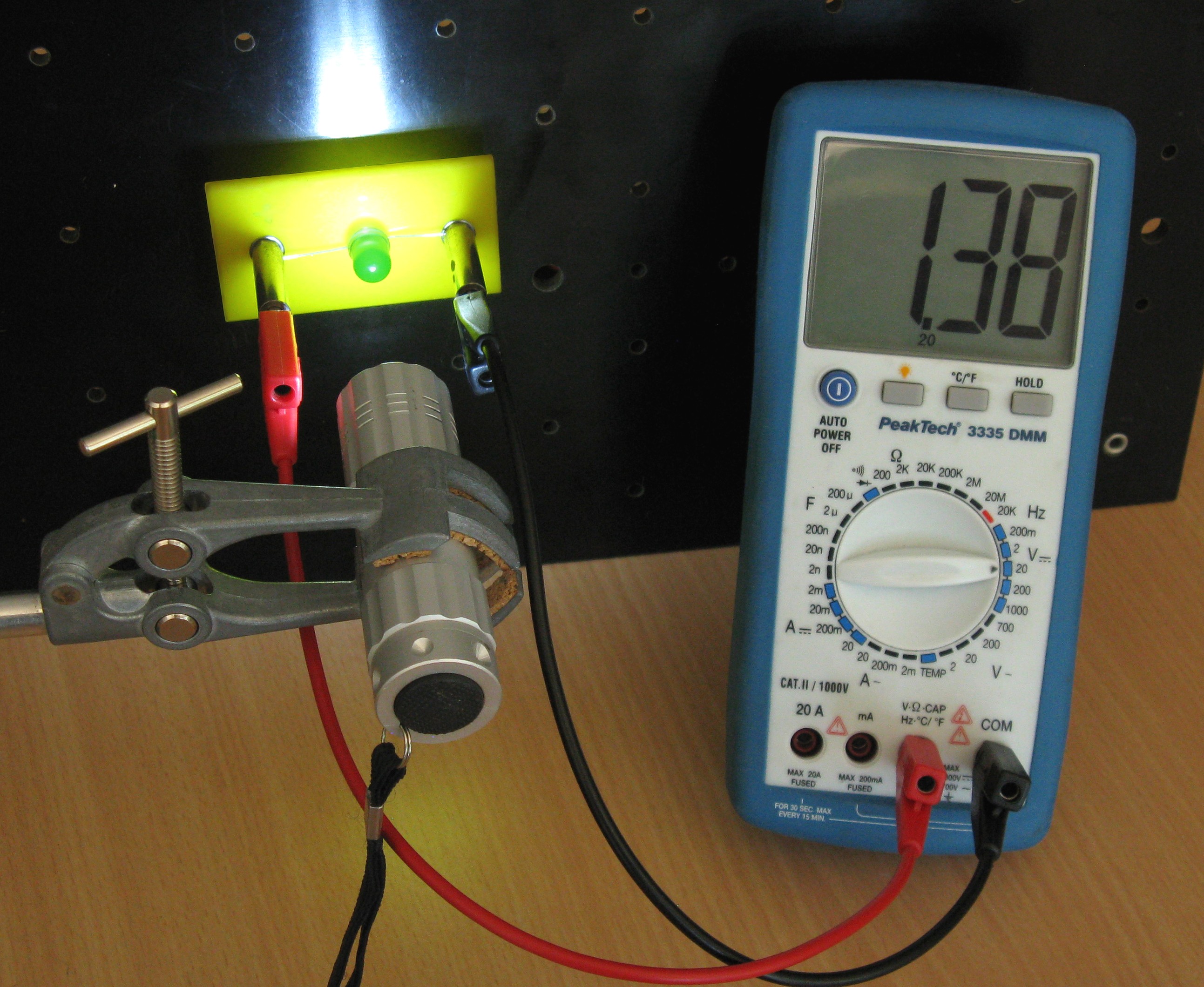 white light shining on green led connected to digital multimeter, output 1.38V