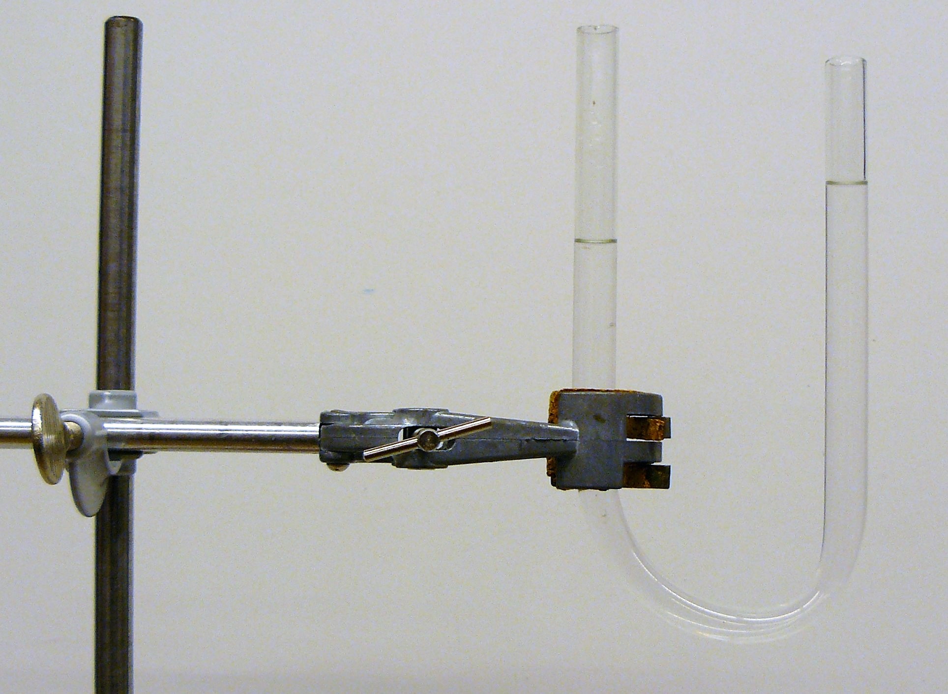 U-shaped tube, liquid at the left is lower than at the right