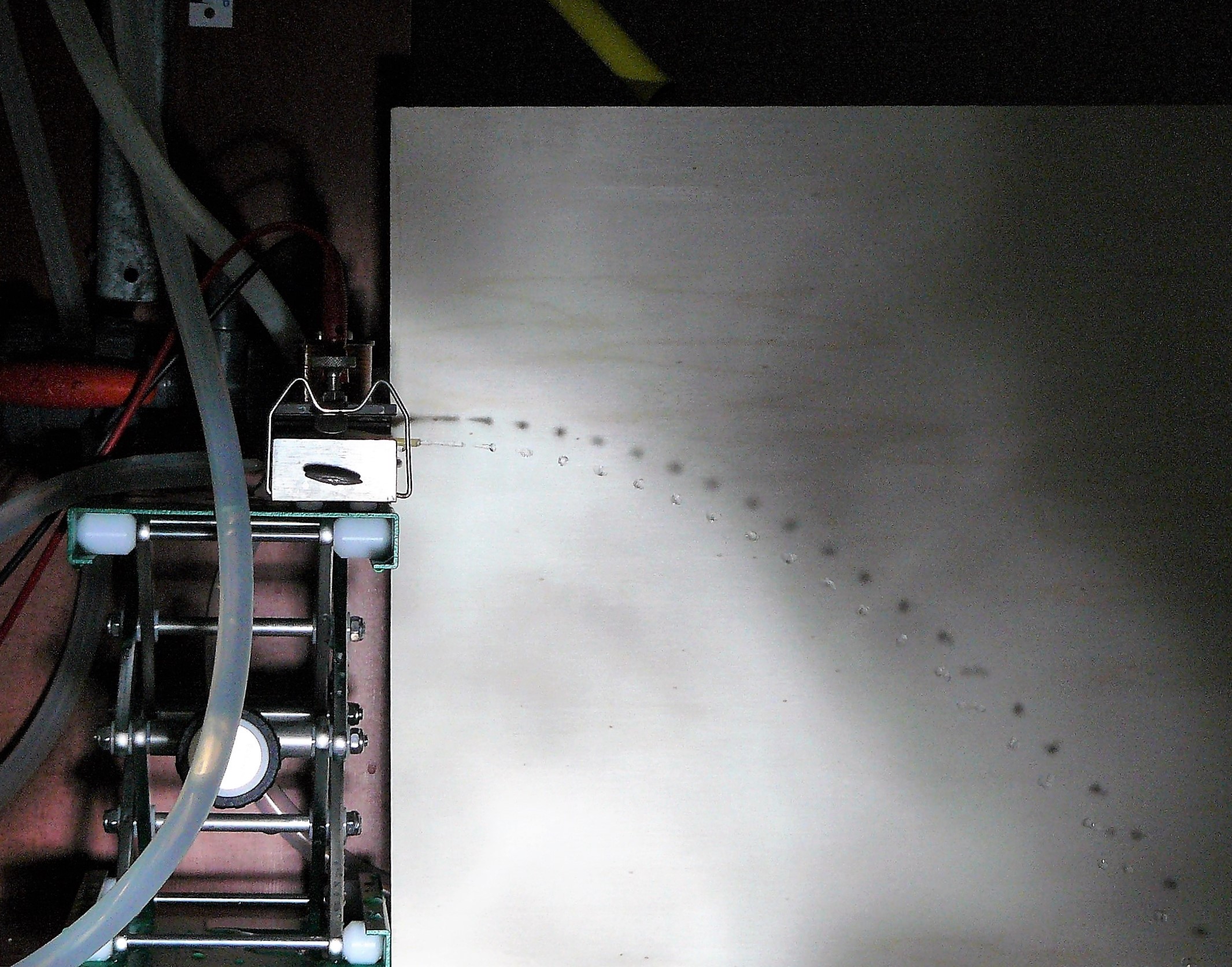 parabolic orbit illustrated by water dropplets